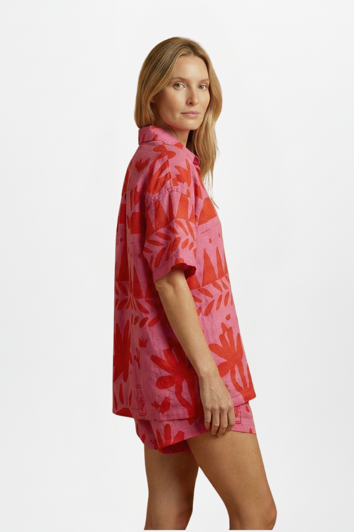 Vibrant tropical print two-piece shorts set for women. Includes a trendy camp collar shirt & comfy matching shorts. Summer fashion.