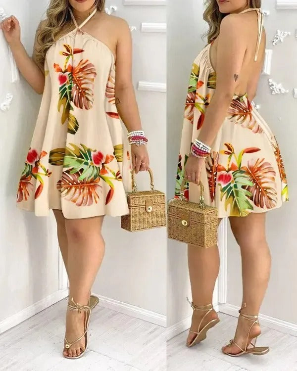 Elegant women's tropical print halter neck dress with a backless design, great for resorts
