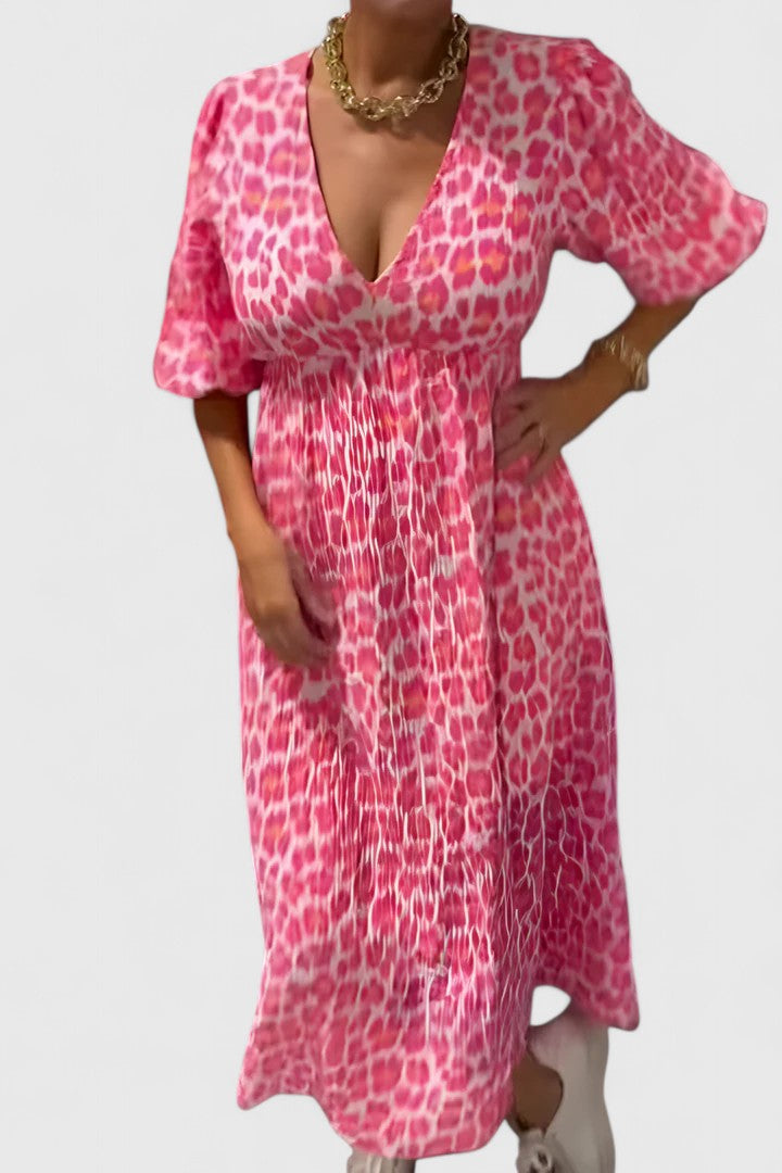 Elegant women's maxi dress with tropical stripe print, V-neck, & chic puff sleeves for summer fashion.