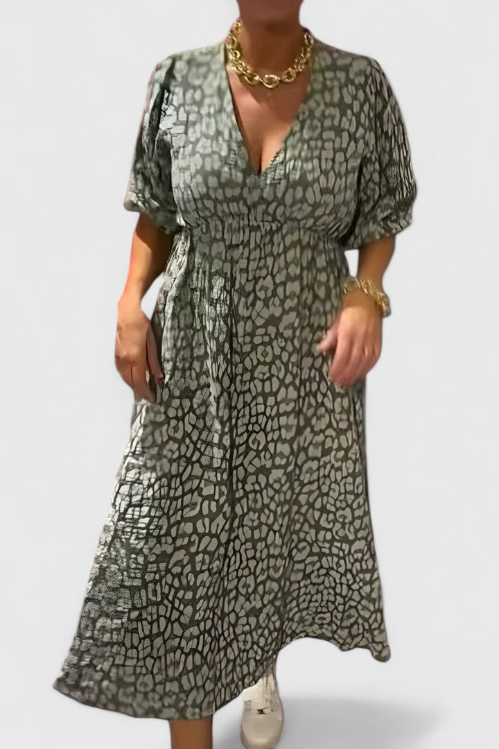 Flowy tropical stripe maxi dress for women, features V-neck, puff sleeves, & empire waist. Ideal resort wear.