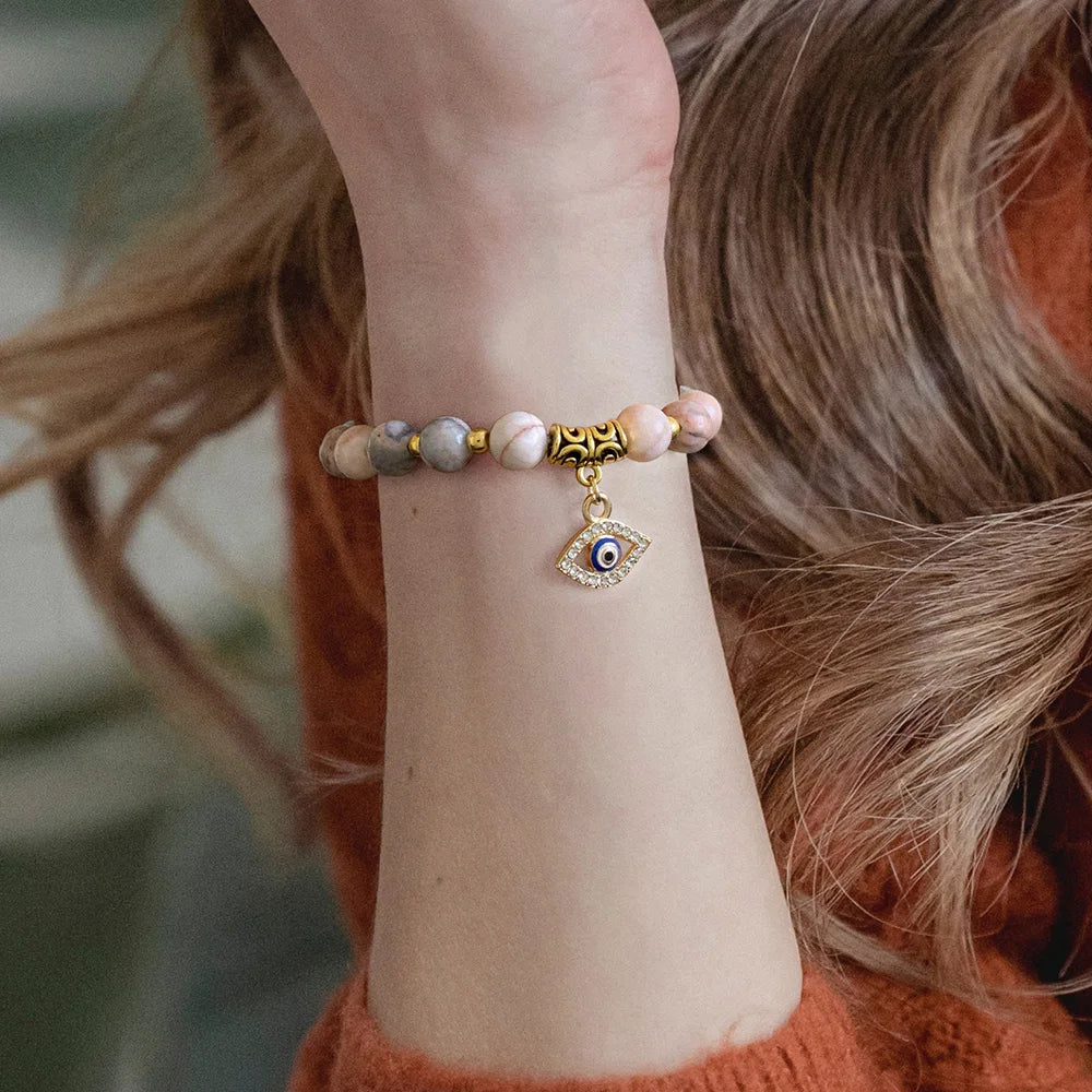 Overhead view of a Turkish Evil Eye pendant protection bead bracelet. Spiritual good luck charm for women.