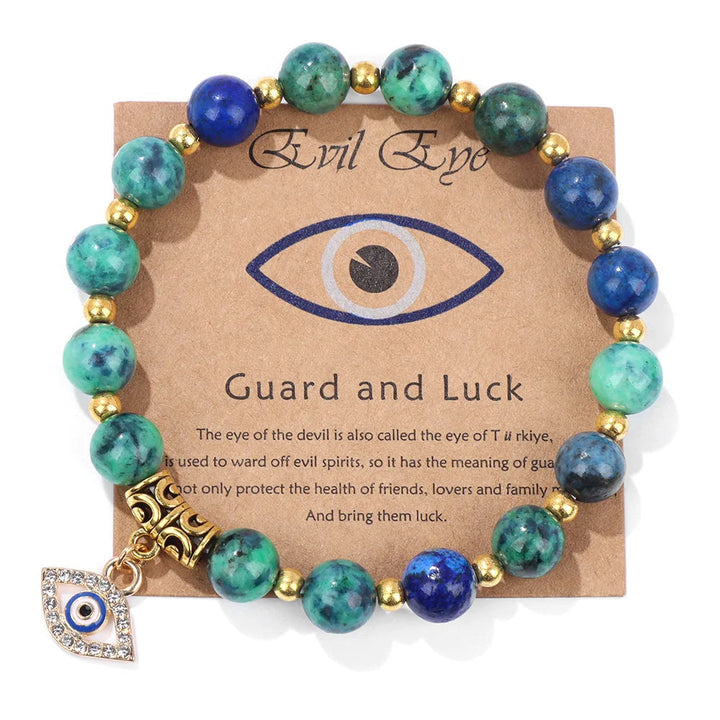 Detailed view of the blue glass Turkish Evil Eye pendant on a beaded protection bracelet for women.