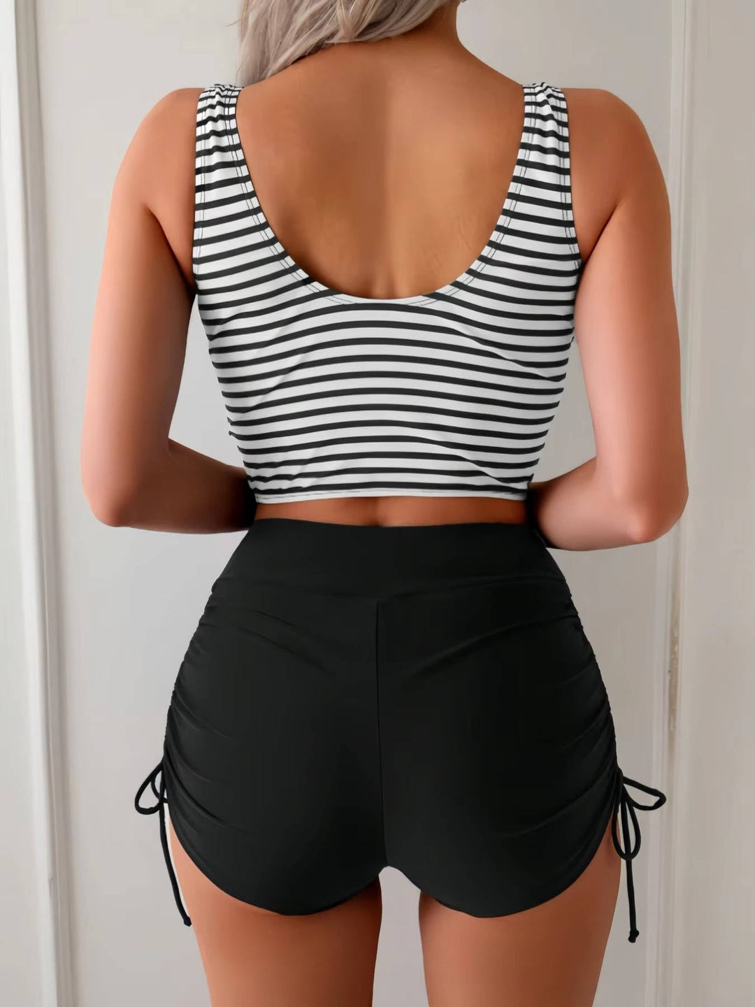 Elegant women's two-piece tankini swimsuit, high waisted bottom & twist front top for summer wear.