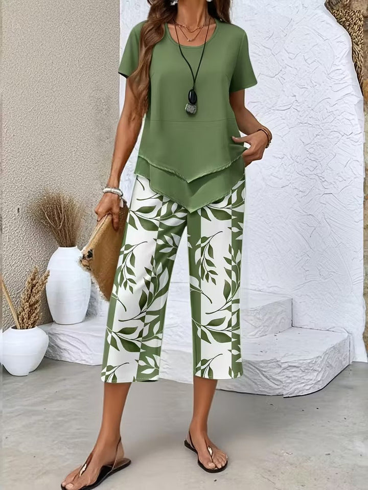 Women's two-piece leaf print outfit with a relaxed top and cropped pants. Perfect for summer casual wear.