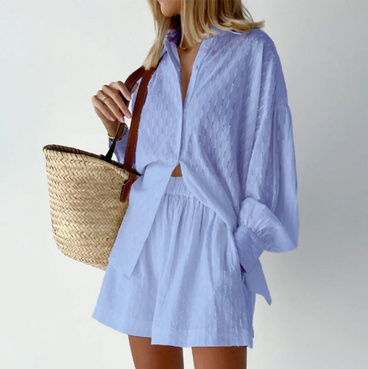 Fashionable women's two-piece summer outfit, featuring a breezy top & shorts with lantern sleeves.