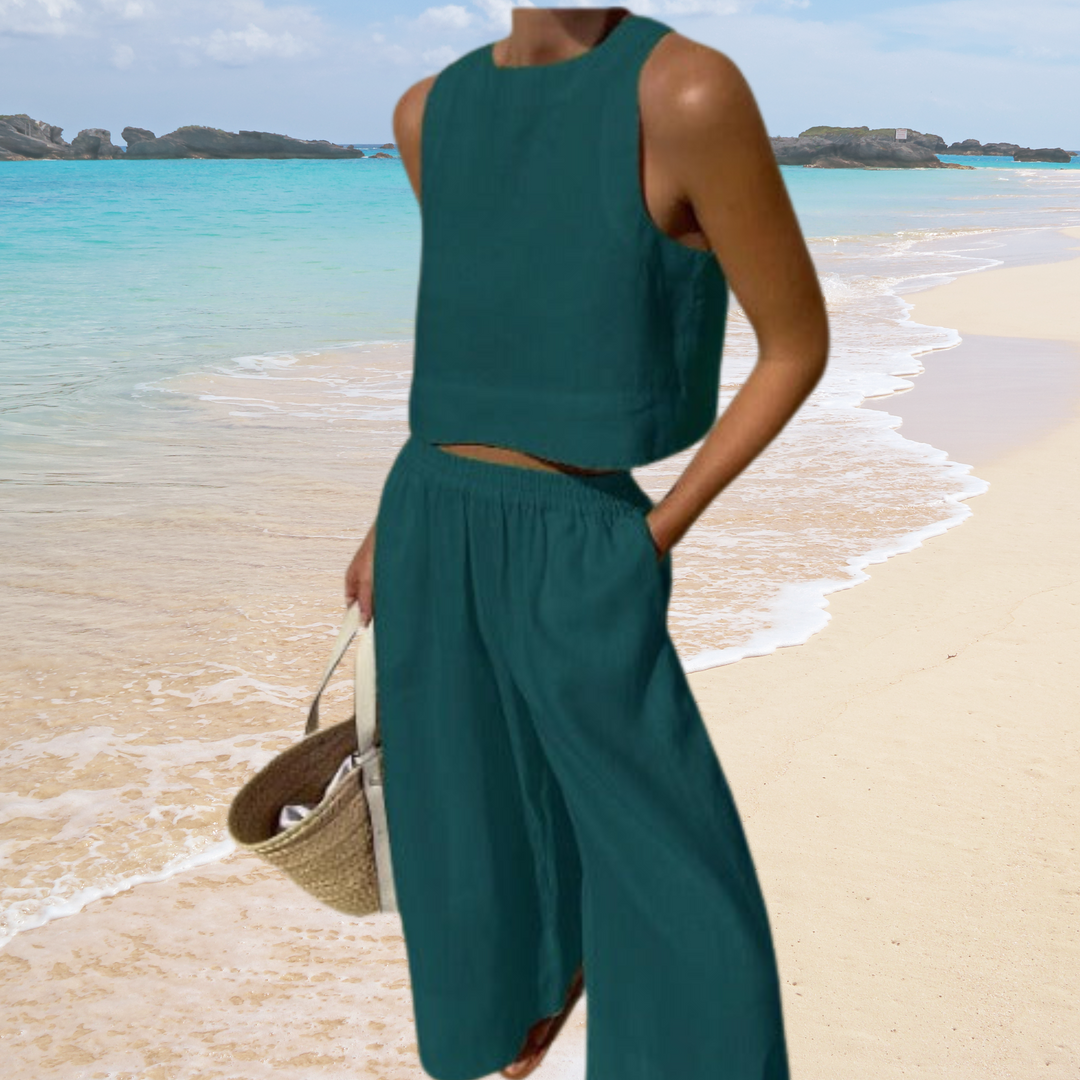 Chic women's two-piece summer outfit: sleeveless crop top & wide-leg pants. Perfect resort wear for vacations.
