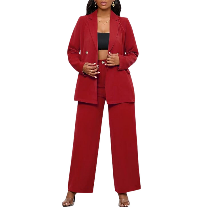 Front view of a woman posing confidently in a two-piece blazer and wide leg trousers business suit.