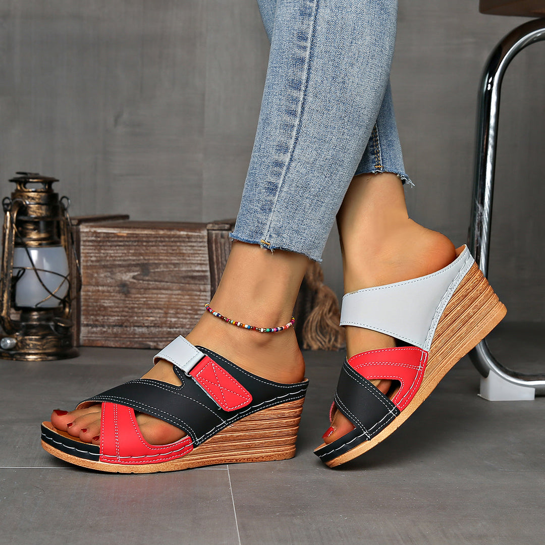 Women's open-toe two-tone wedge slides, providing slip-on comfort for all summer adventures.