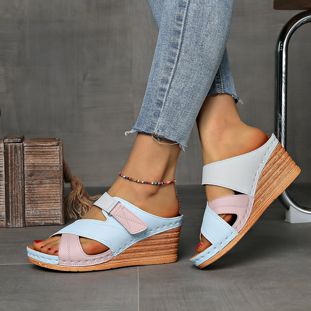 Detailed view of women's two-tone wedge slides, showcasing open toe & comfortable design.
