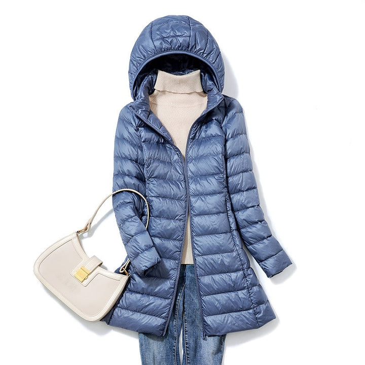 Warm hooded puffer jacket for women, lightweight & insulated, ideal winter outerwear.