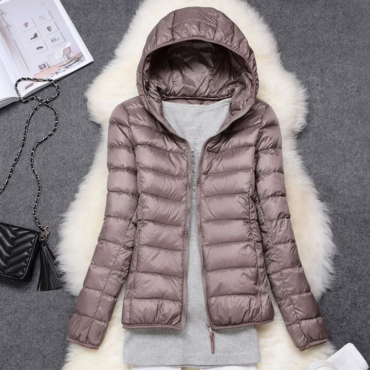 Women's ultralight packable insulated hooded jacket, perfect for travel & outdoor gear.