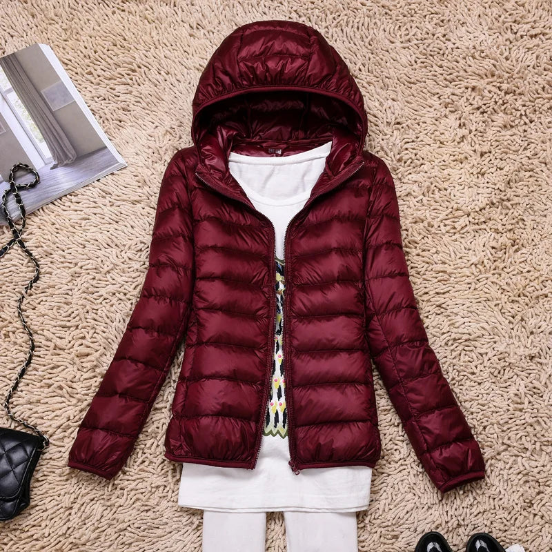 Packable insulated hooded jacket for women, great for hiking & travel.