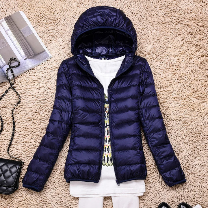 Women's lightweight outdoor gear, insulated, hooded, and packable for all seasons.