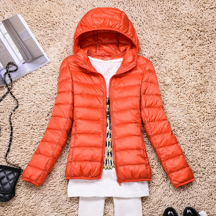 Women's ultralight hooded jacket, insulated for warmth, packable for convenience.