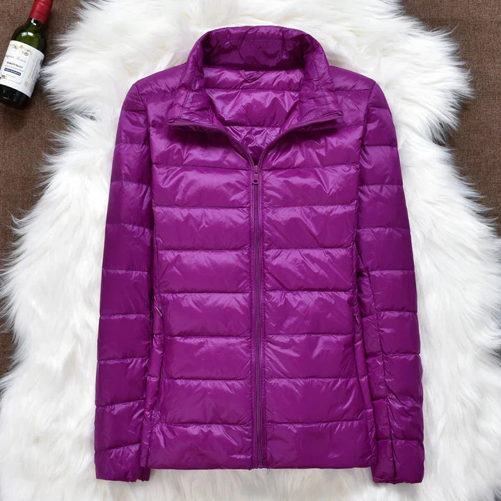 Packable women's outdoor jacket, ultralight, insulated, hooded, for versatile use.