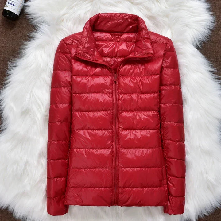 Women's cold weather travel jacket, insulated, hooded, ultralight, and easily packed.