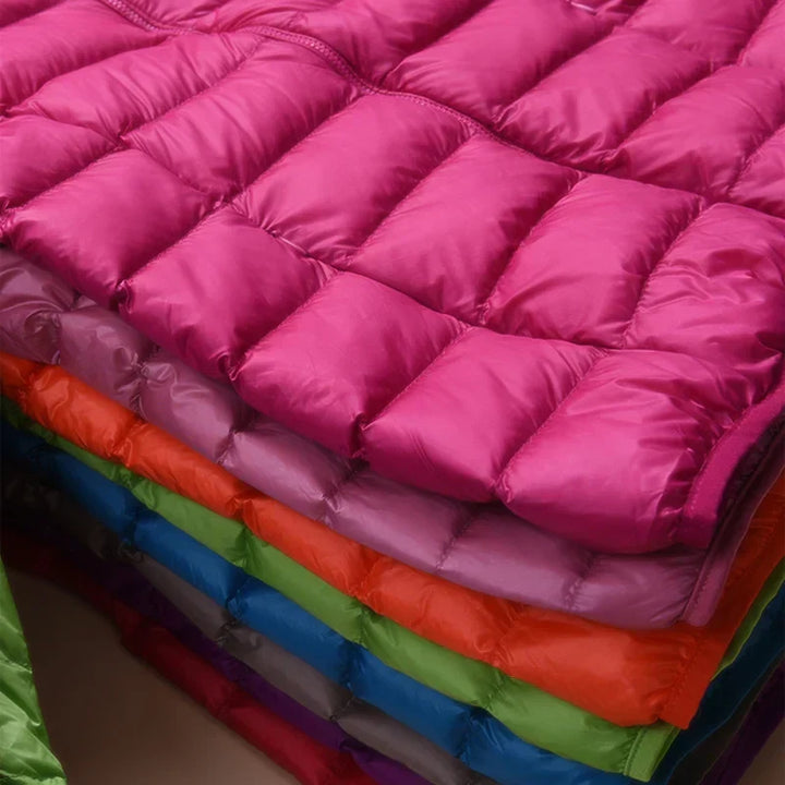 Stylish women's hooded jacket, insulated & packable for outdoor adventures.