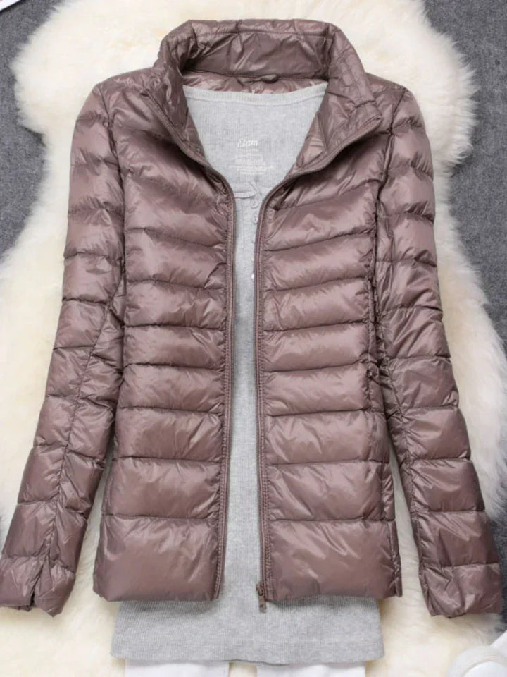 Women's cold weather jacket, packable, insulated hood, lightweight for winter.