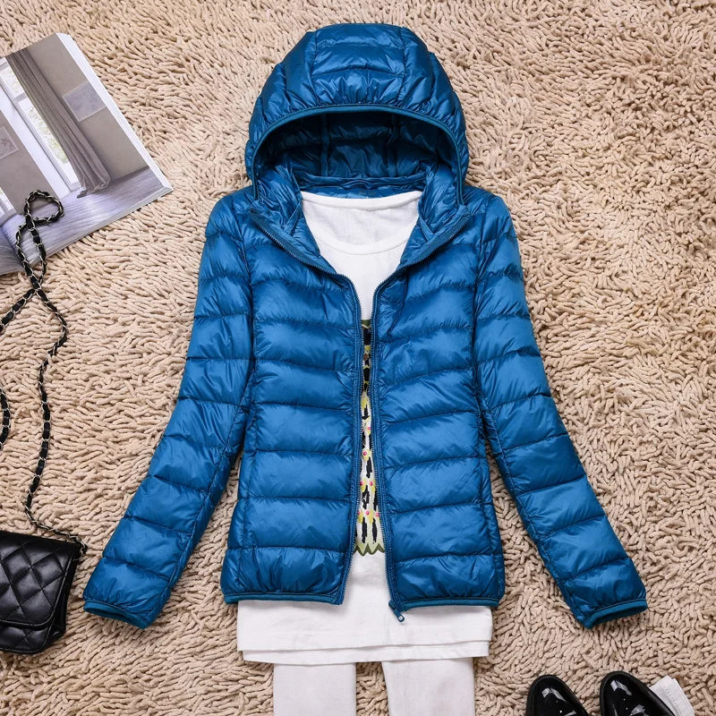 Versatile women's insulated zippered jacket, ultralight & hooded, for outdoor gear.