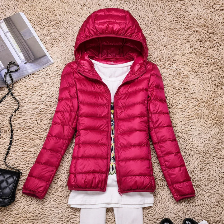 Ultralight women's winter jacket with insulated hood & full zipper for comfort.