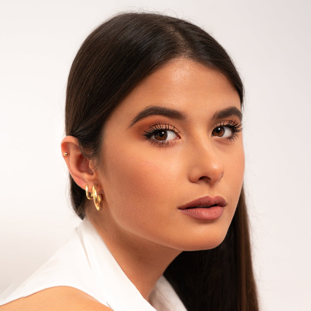 Sterling silver minimalist hoop earrings for women. Elegant and unique everyday jewelry with a subtle design.