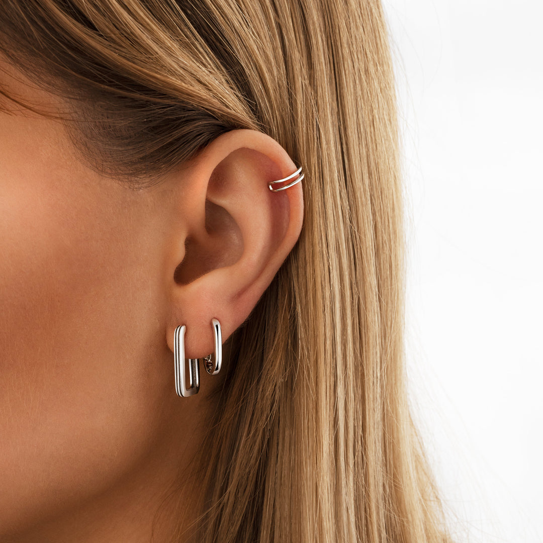 Gold tone unique hoop earrings for women. Sleek minimalist design, ideal everyday fashion statement jewelry.