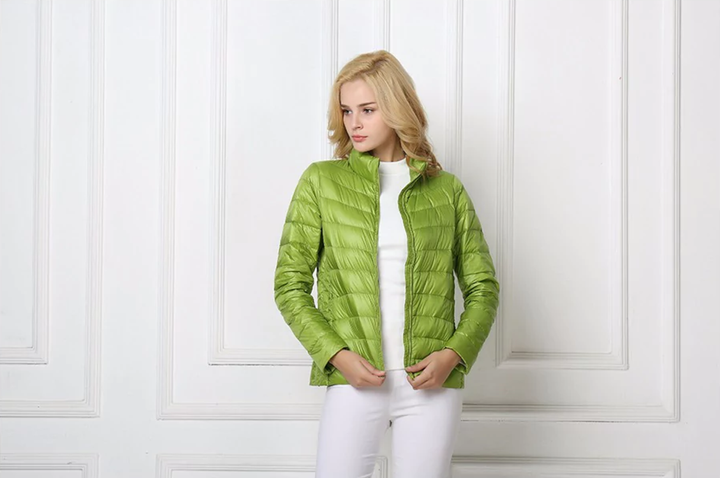 Detail of women's lightweight puffer jacket zipper, emphasizing its modern urban design & functionality.