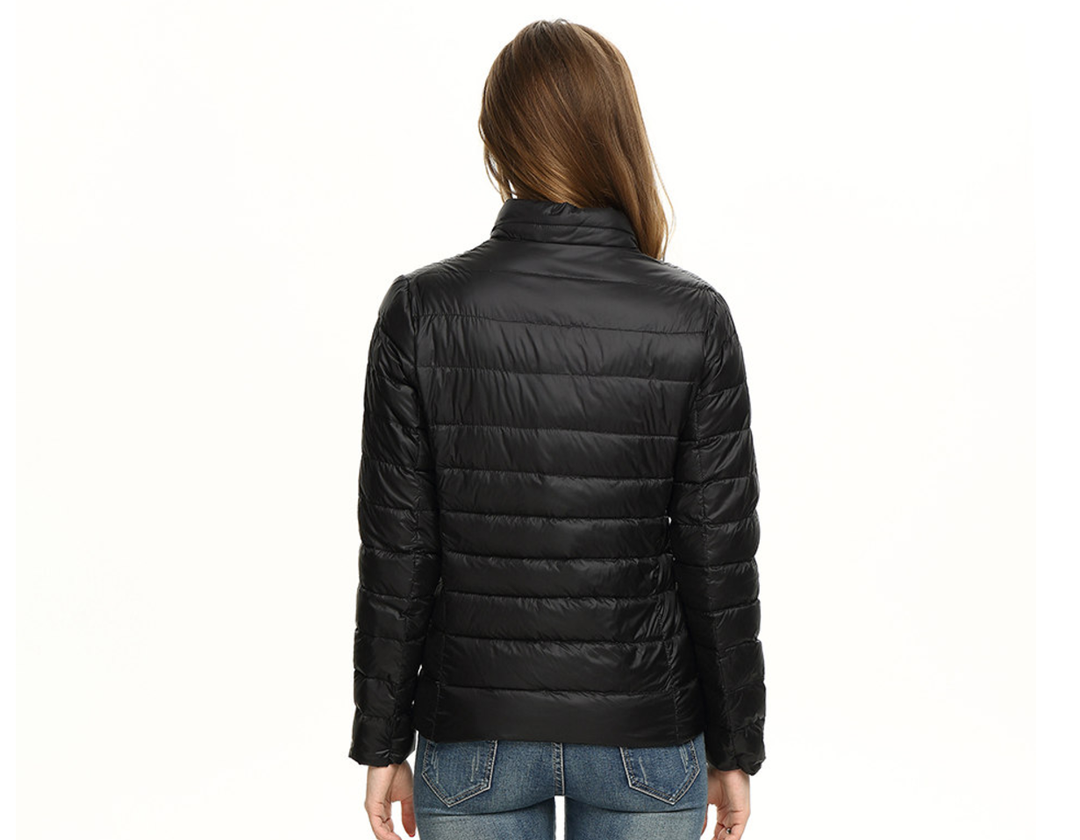Packable women's travel jacket, a lightweight urban chic puffer for effortless style on the go.