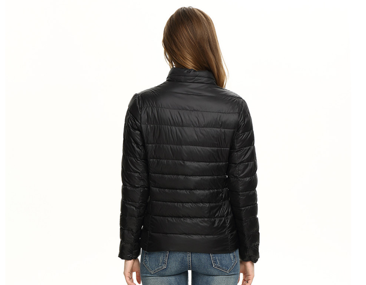 Packable women's travel jacket, a lightweight urban chic puffer for effortless style on the go.