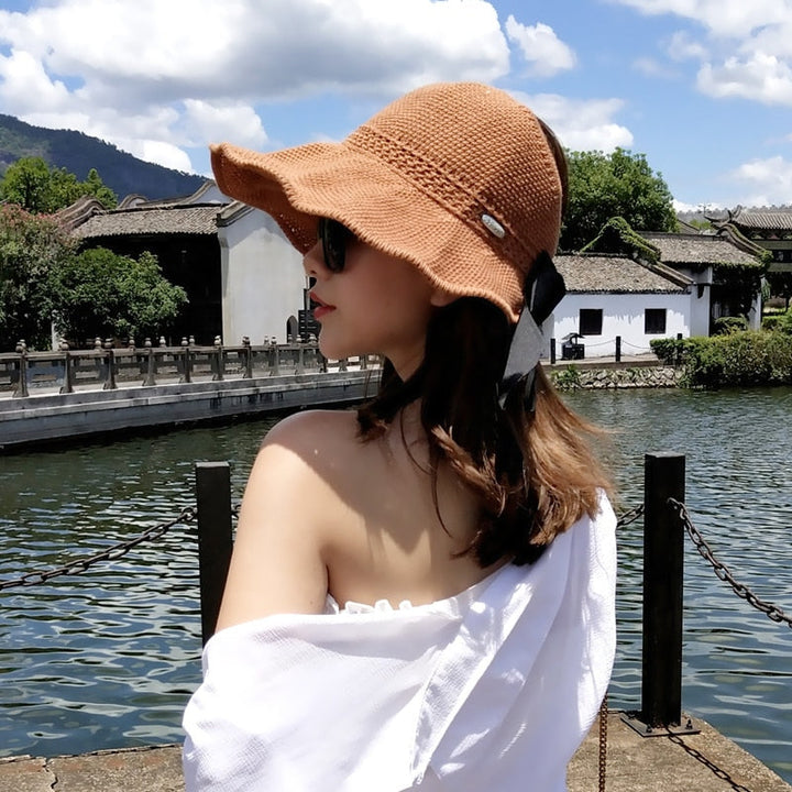 Ponytail straw sun hat for women, offering UPF 50+ UV protection, a summer beach essential