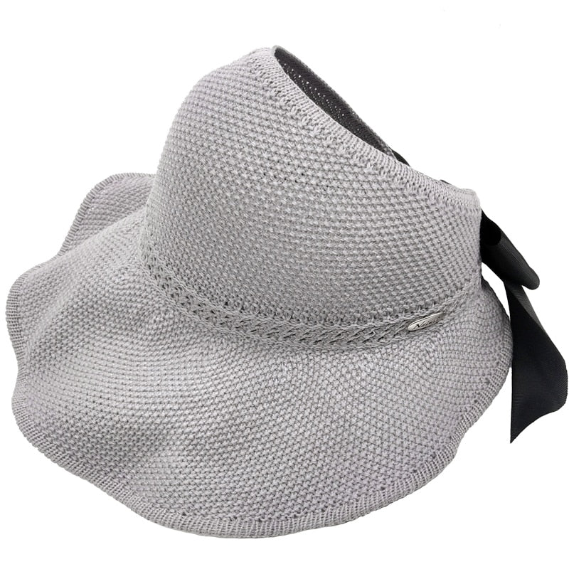 Rollable women's straw hat with ponytail hole, fashionable & protective from sun, travel-friendly