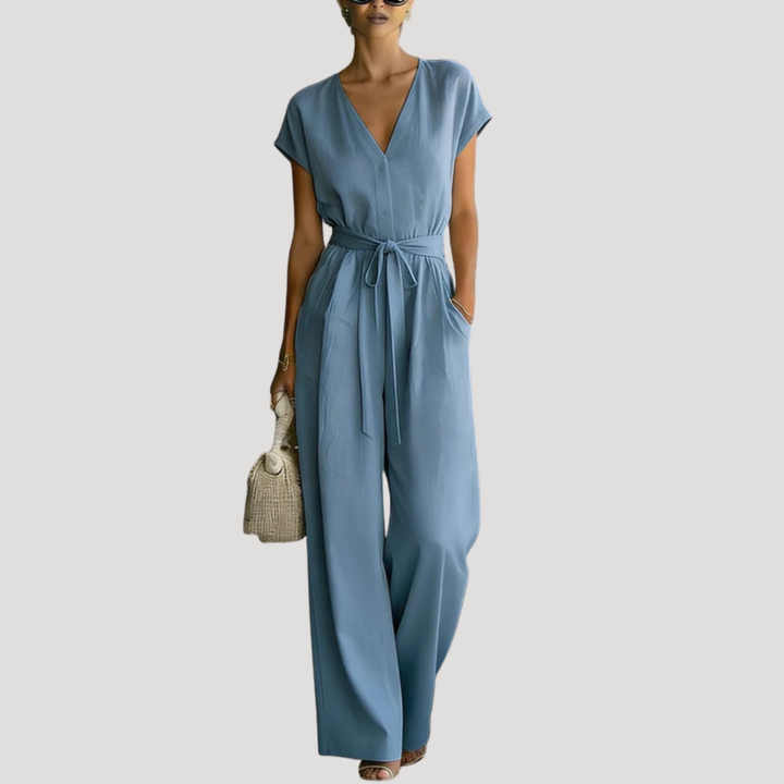 Comfortable women's wide leg jumpsuit, featuring V-neck, cap sleeves & tie waist, ideal for versatile casual chic style.