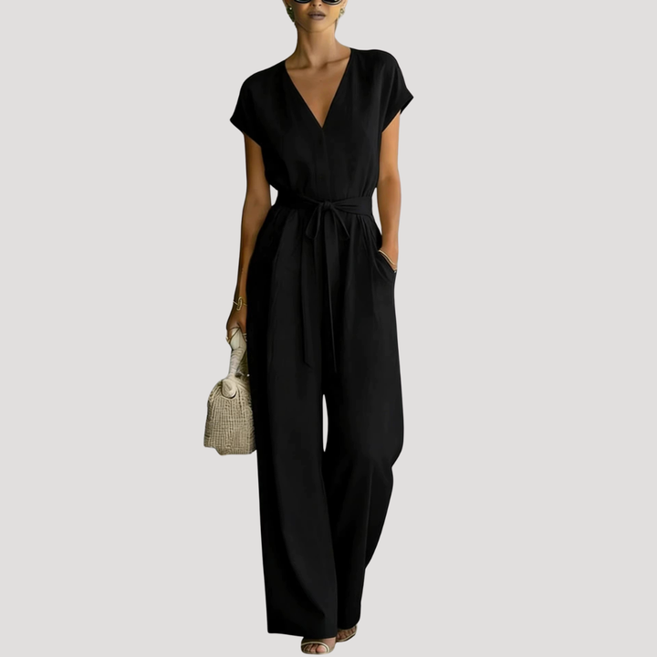 Stylish women's one-piece V-neck jumpsuit with cap sleeves, flowy wide legs & adjustable tie waist for summer.