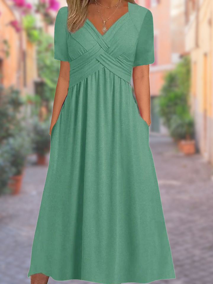 Chic V-neck midi dress with unique crisscross bodice, perfect for cocktail parties & sophisticated wear.