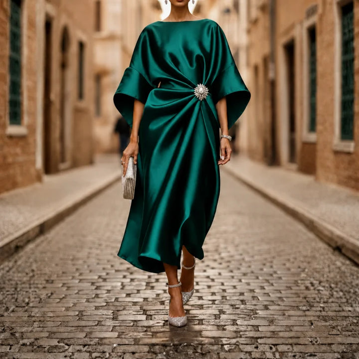 Flowing women's midi dress with a V-neck, elbow sleeves, and a flared skirt. Perfect for spring & summer style.