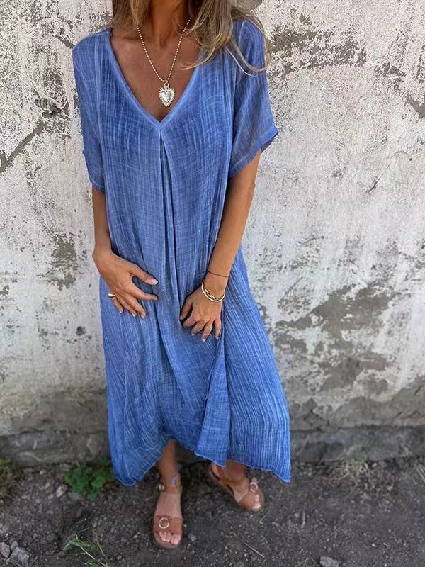 Flowy women's midi dress with V-neck & short sleeves, ideal for beach or casual outings.