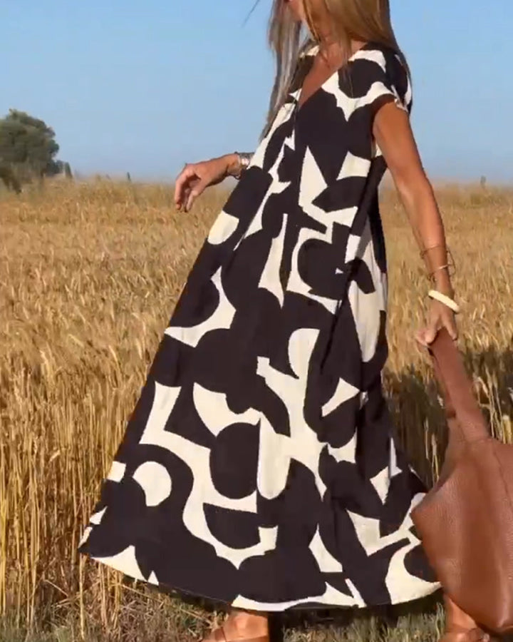 Elegant V-Neck Maxi Dress with vibrant print, ideal for spring fashion and vacation outfits.