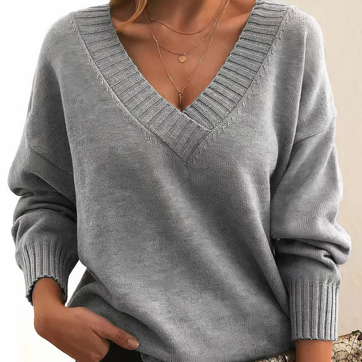 Winter style women's V-neck ribbed sweater, relaxed fit long sleeve top for warmth.