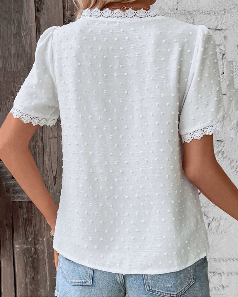 Textured Swiss dot V-neck top for women, featuring elegant lace trim & a relaxed, casual fit.