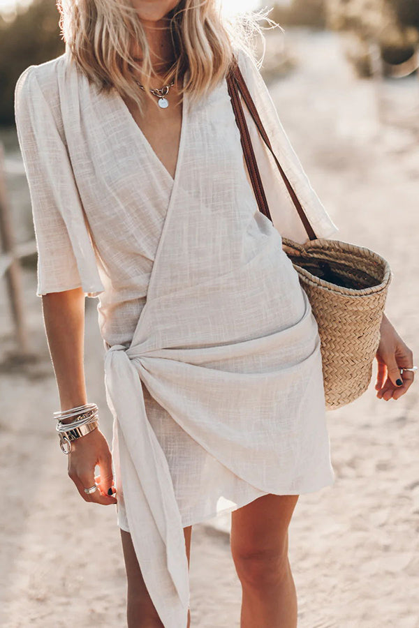 Women's V-neck tie-waist wrap mini dress with short sleeves, perfect for summer casual or vacation style.