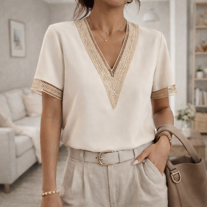 Women's V-neck top with elegant lace trim, a feminine blouse perfect for spring & summer fashion.