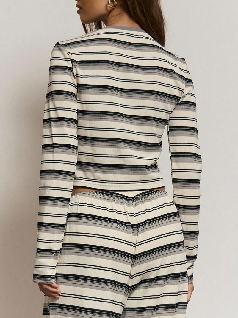 Woman relaxing in a comfortable striped knit loungewear set, perfect for cozy evenings at home.