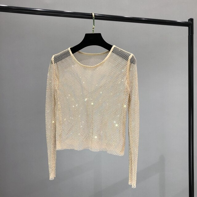 Fashionable women's shiny long sleeve top, featuring eye-catching rhinestones for a glamorous party look.