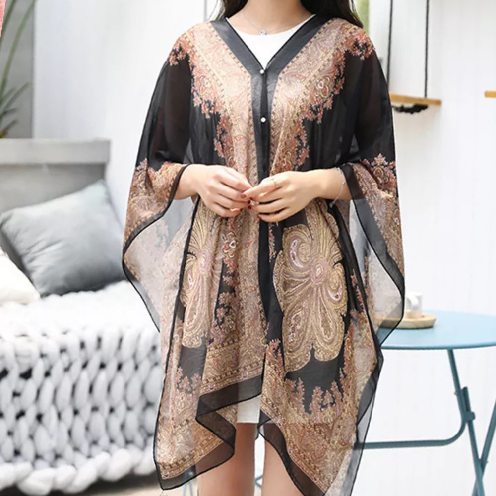 Black chiffon versatile poncho scarf for women, a lightweight and elegant fashion accessory. Wear as a wrap or shawl.