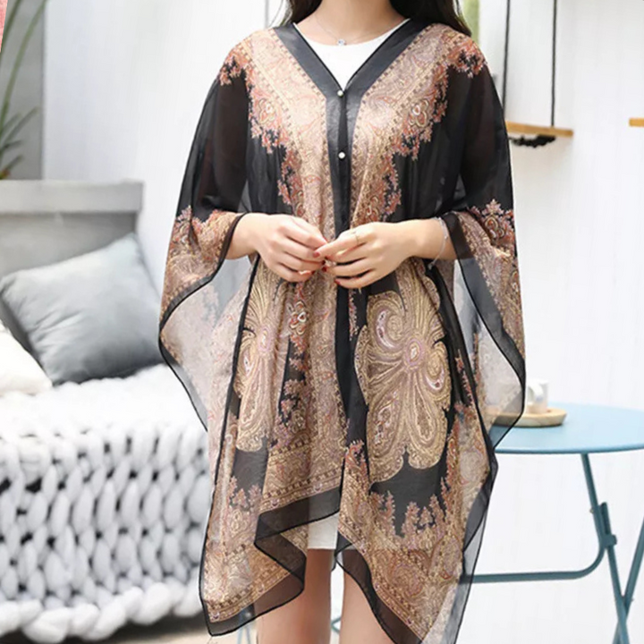 Black chiffon versatile poncho scarf for women, a lightweight and elegant fashion accessory. Wear as a wrap or shawl.