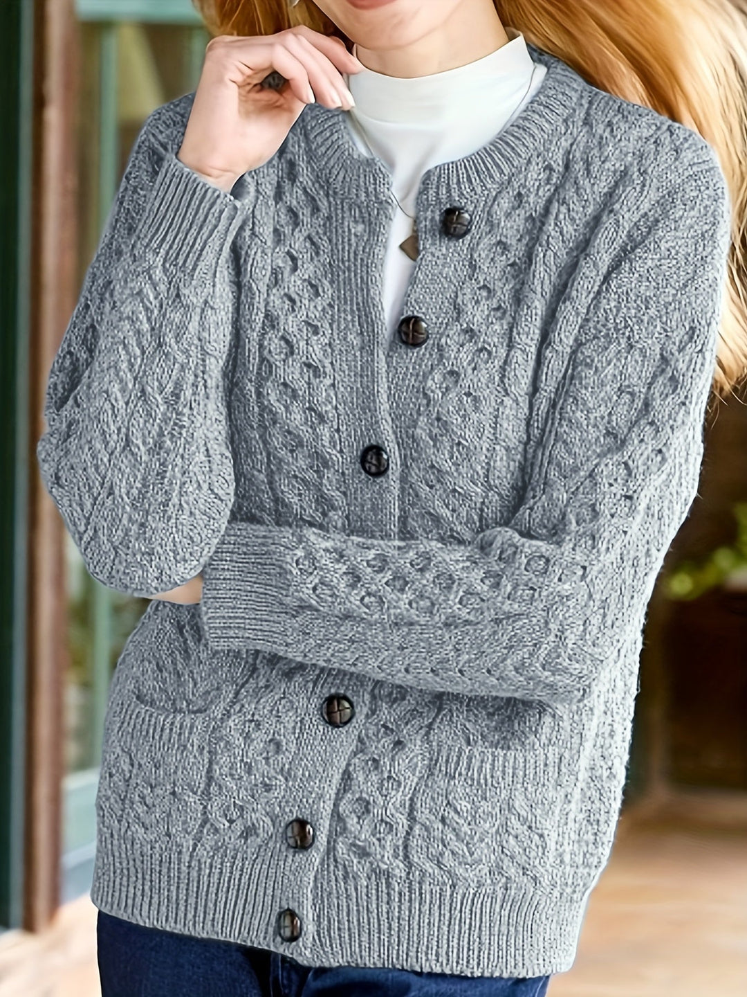 Elegant black long sleeve women's cardigan, featuring a button-down front and practical pockets.