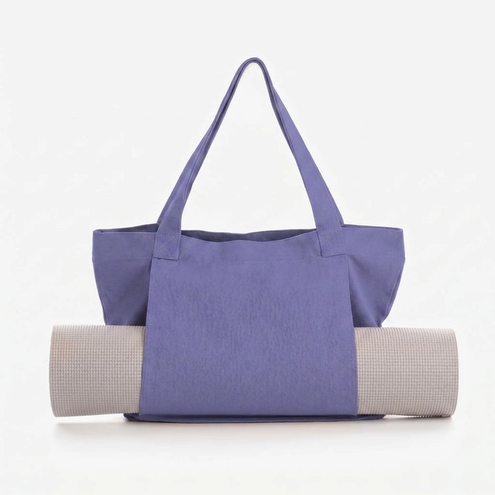 Woman carries a versatile canvas yoga mat tote bag, ideal for gym, fitness, and yoga classes.