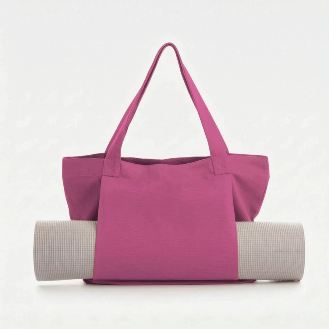 Durable women's yoga mat gym bag. Canvas shoulder tote with ample space for accessories.