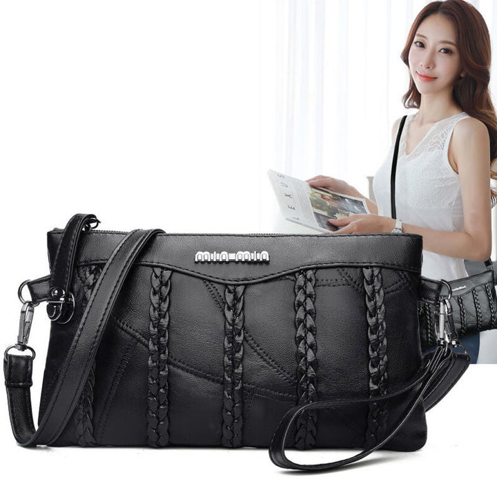 Modern women's PU leather clutch bag held in hand, showcasing its compact yet spacious design for essentials.