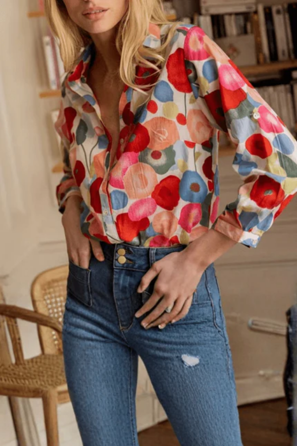 Elegant women's vibrant floral collared blouse. Versatile button-down top for day-to-night spring fashion.